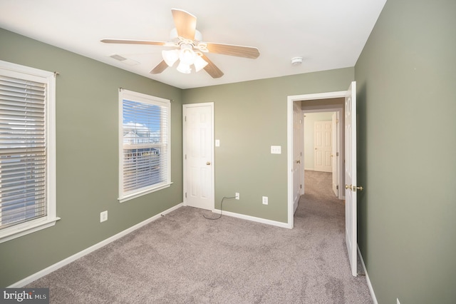 unfurnished bedroom featuring light colored carpet and ceiling fan