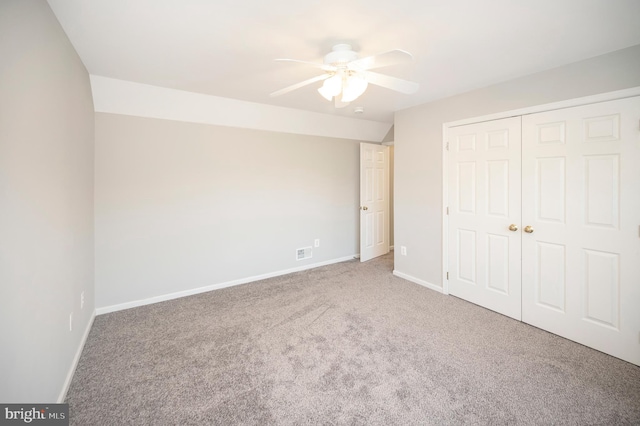 unfurnished bedroom featuring ceiling fan, a closet, and carpet floors