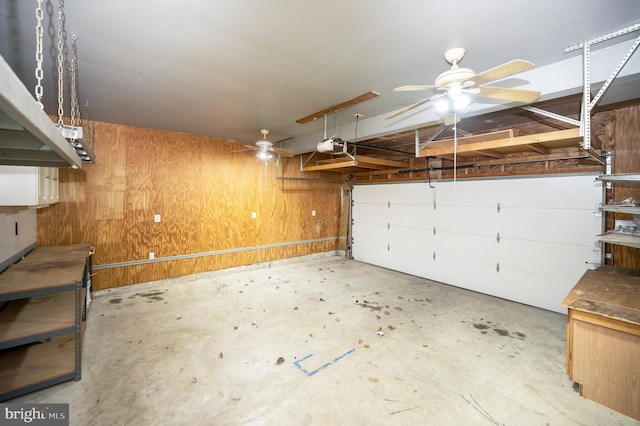 garage with wood walls and a garage door opener