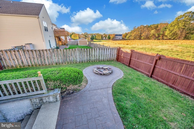 view of yard with a patio area and an outdoor fire pit