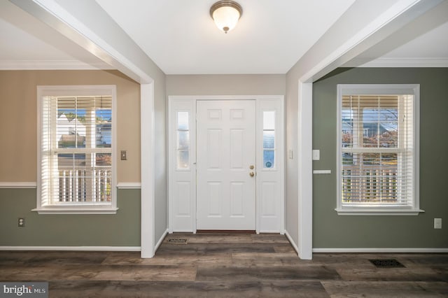 entrance foyer with crown molding and dark hardwood / wood-style flooring