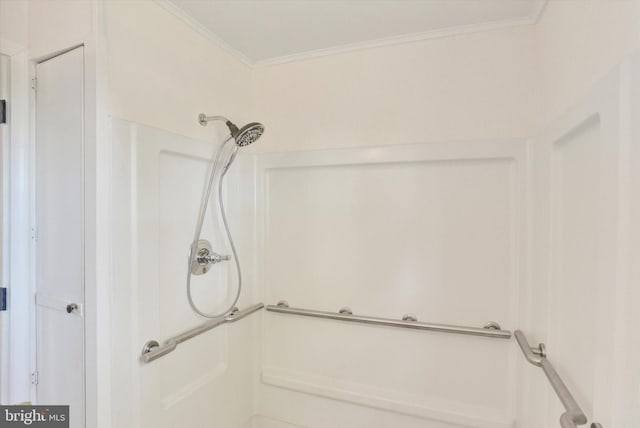 bathroom with a shower and ornamental molding