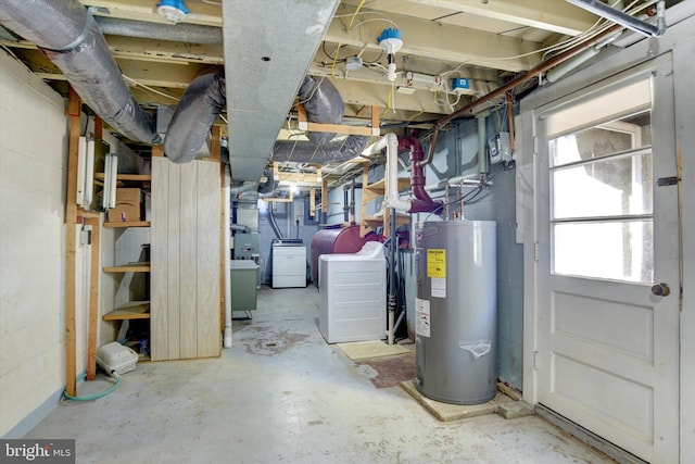 basement with washing machine and clothes dryer and electric water heater