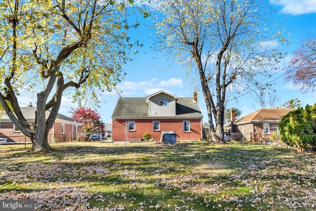 back of house with a lawn