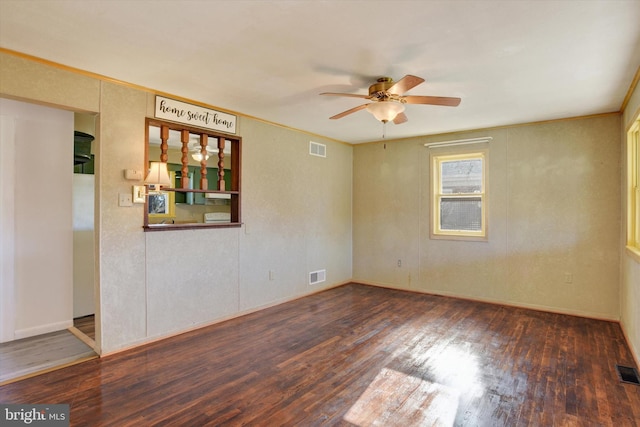 spare room featuring dark hardwood / wood-style flooring and ceiling fan