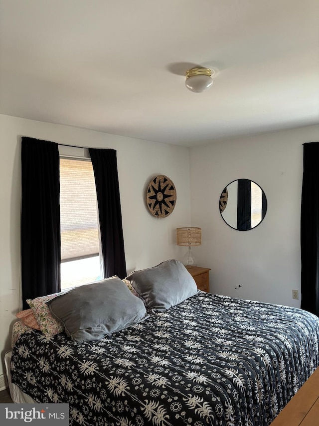 bedroom with hardwood / wood-style flooring