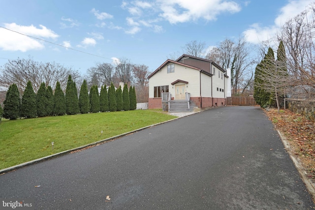 view of side of property featuring a yard