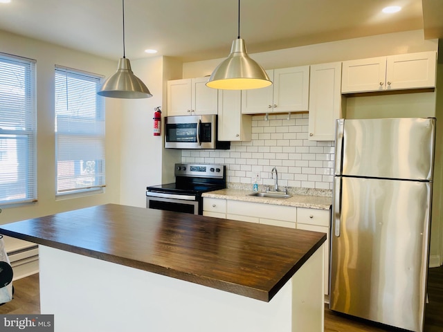1525 W Wyoming Ave, Philadelphia, PA 19140 - kitchen featuring stainless steel appliances, a sink, wooden counters, tasteful backsplash, and recessed lighting