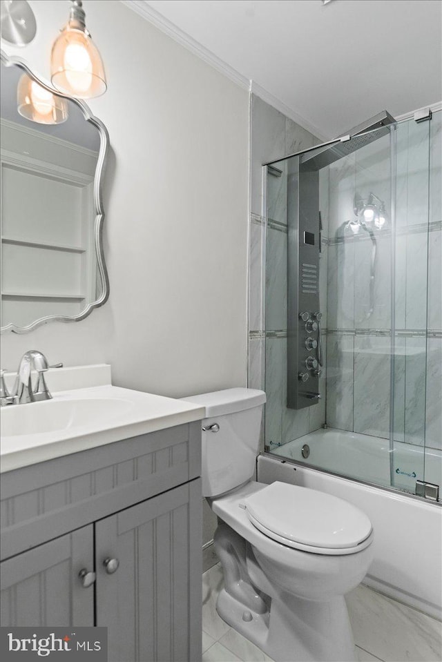 full bathroom featuring vanity, ornamental molding, shower / bath combination with glass door, and toilet