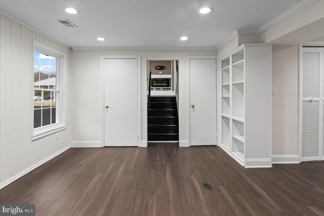 interior space with crown molding, dark hardwood / wood-style floors, and white cabinets