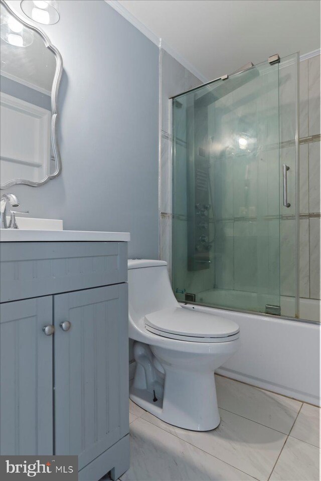 full bathroom featuring ornamental molding, vanity, toilet, and combined bath / shower with glass door