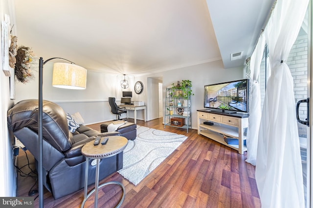 living room featuring dark hardwood / wood-style floors and ornamental molding