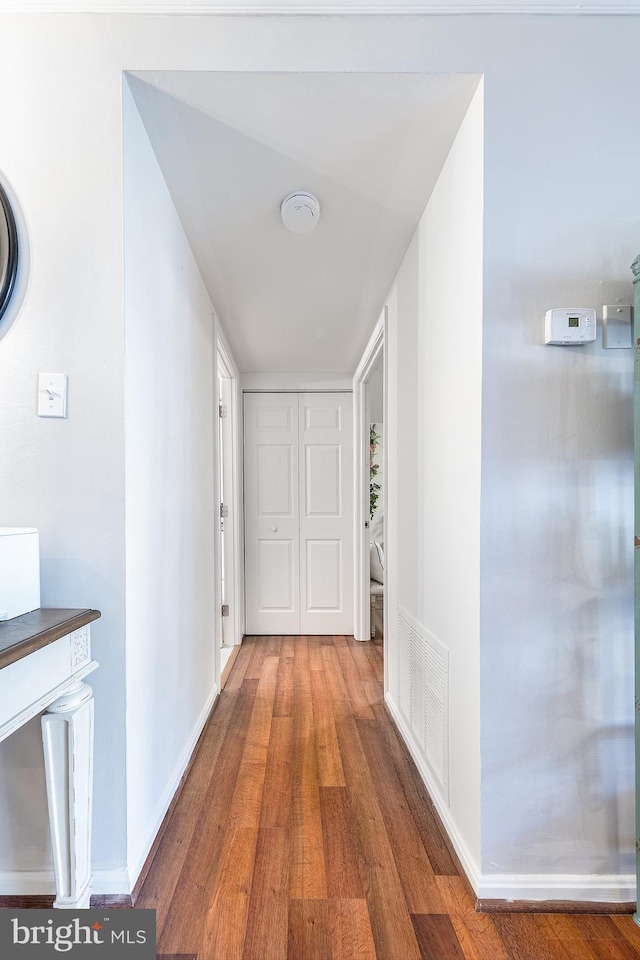 corridor featuring wood-type flooring