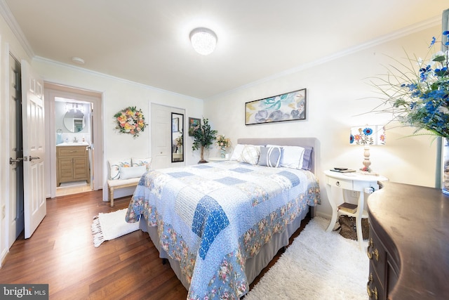 bedroom featuring ensuite bathroom, dark hardwood / wood-style flooring, and crown molding