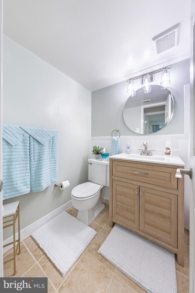 bathroom featuring tile patterned flooring, vanity, and toilet