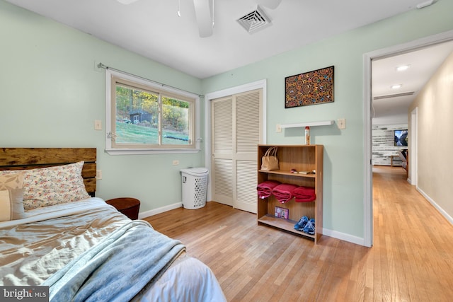 bedroom with a closet, ceiling fan, and light hardwood / wood-style floors