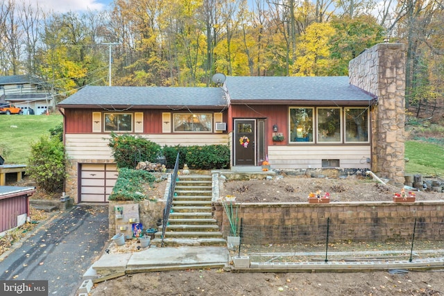 316 Spring Valley Rd, Reading, PA 19605 - view of front facade featuring a shingled roof, driveway, stairway, and an attached garage
