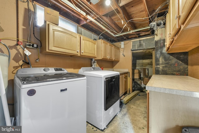 washroom featuring washer and clothes dryer and cabinets