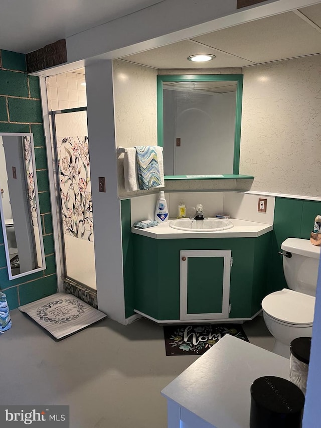 316 Spring Valley Rd, Reading, PA 19605 - bathroom featuring toilet, vanity, a wainscoted wall, finished concrete floors, and a textured wall