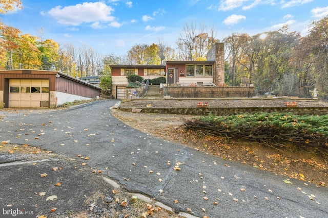 316 Spring Valley Rd, Reading, PA 19605 - view of front of property featuring a garage, a chimney, stairway, and an outbuilding