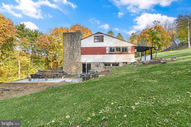 rear view of property with a lawn and a patio area