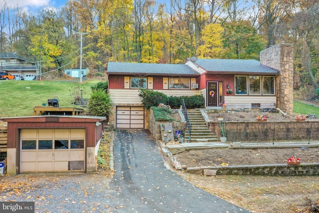 view of front of home with a garage and a front yard