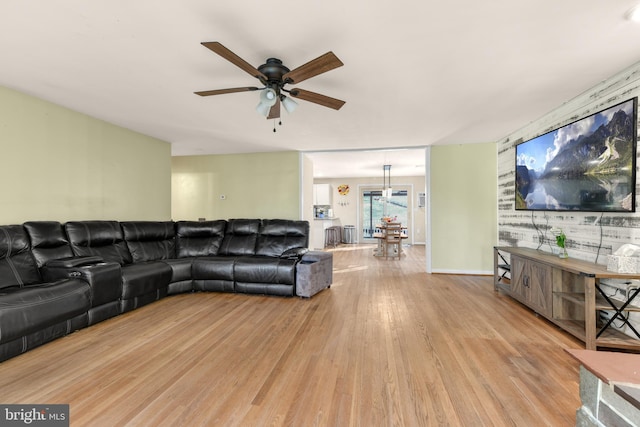 living room featuring ceiling fan and light hardwood / wood-style floors