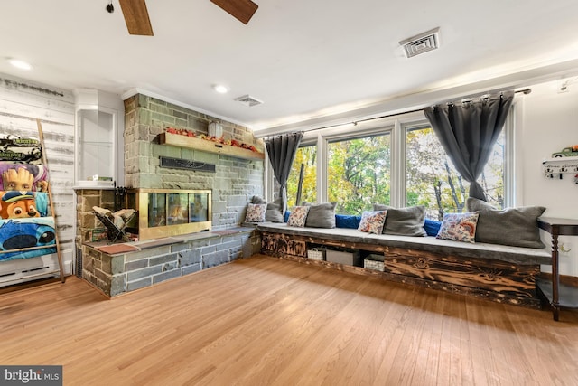 316 Spring Valley Rd, Reading, PA 19605 - living area with wood finished floors, ceiling fan, and a stone fireplace