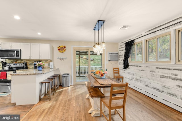 316 Spring Valley Rd, Reading, PA 19605 - dining room with light wood-style flooring, plenty of natural light, a wall unit AC, and recessed lighting
