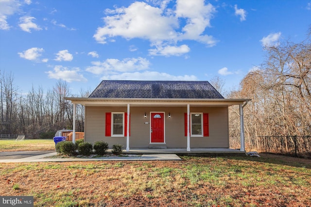 view of front of property with covered porch and a front yard