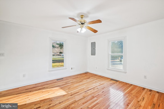 unfurnished room featuring electric panel, ceiling fan, and light wood-type flooring