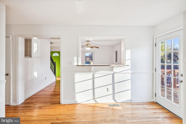 spare room with ceiling fan and light wood-type flooring