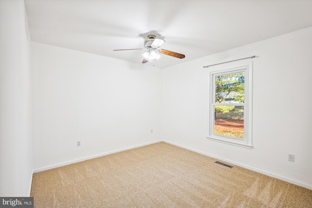 carpeted empty room featuring ceiling fan