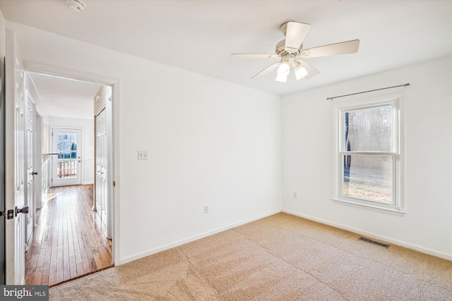 spare room with ceiling fan and hardwood / wood-style floors