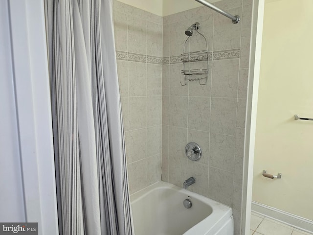 bathroom featuring shower / bath combo with shower curtain and tile patterned flooring