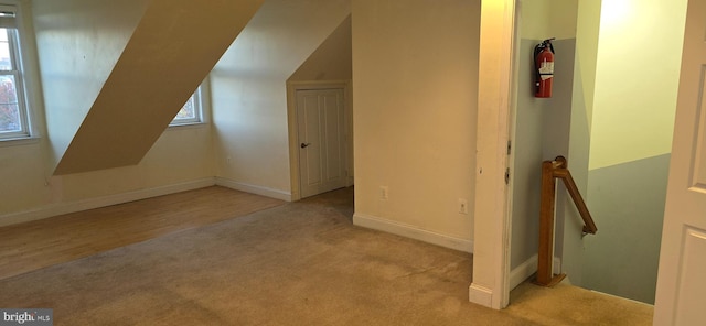 additional living space with light colored carpet