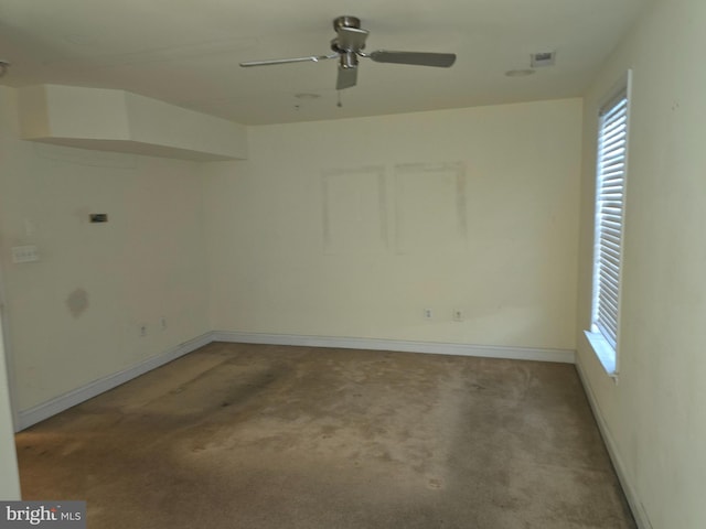 carpeted empty room featuring a wealth of natural light and ceiling fan