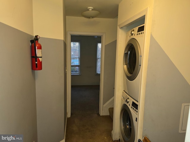 clothes washing area with stacked washer and clothes dryer