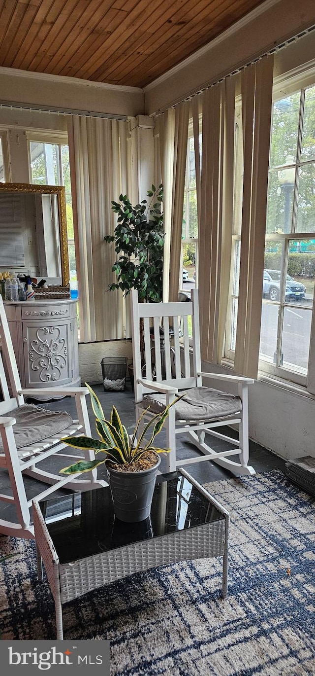 sunroom / solarium with wood ceiling and a healthy amount of sunlight