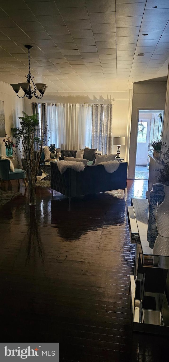 living room with wood-type flooring and a notable chandelier