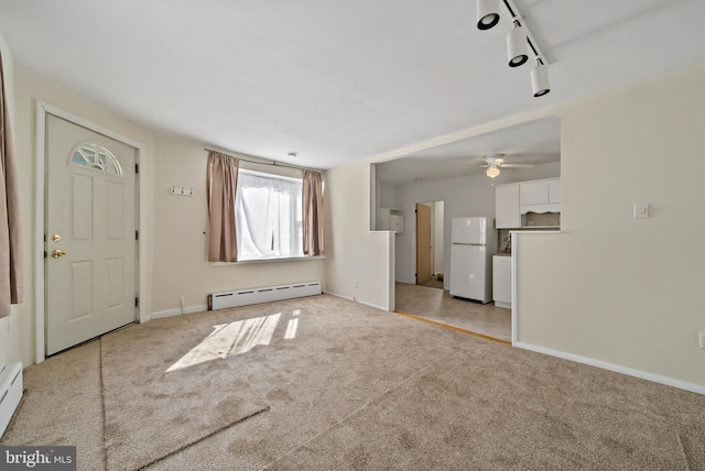 unfurnished living room with light carpet, a baseboard radiator, and ceiling fan