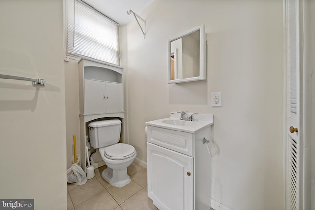 bathroom featuring toilet, vanity, and tile patterned floors