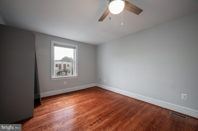 empty room with wood-type flooring and ceiling fan