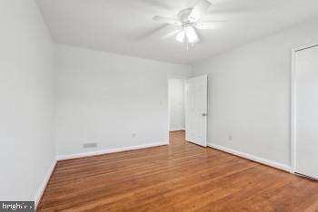 spare room featuring hardwood / wood-style flooring and ceiling fan