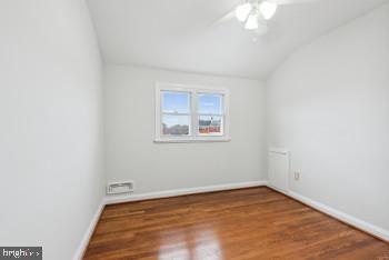 unfurnished room featuring wood-type flooring, ceiling fan, and lofted ceiling