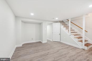 basement with light hardwood / wood-style floors