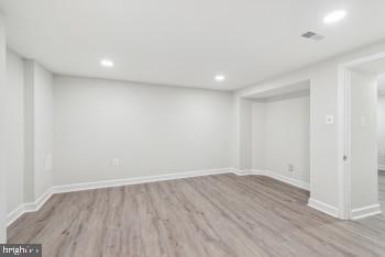 basement with light hardwood / wood-style flooring