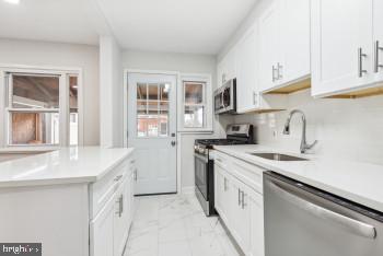 kitchen with white cabinets, sink, and stainless steel appliances