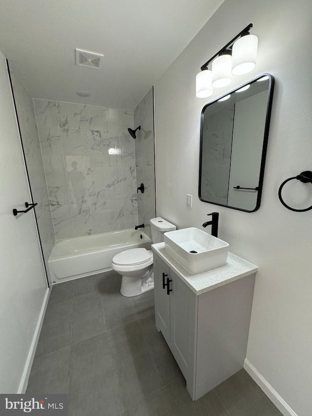 full bathroom featuring vanity, tile patterned flooring, tiled shower / bath, and toilet