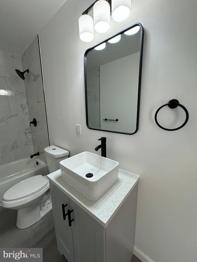 full bathroom featuring tiled shower / bath, vanity, toilet, and tile patterned floors